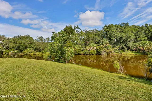 a view of a lake with a yard