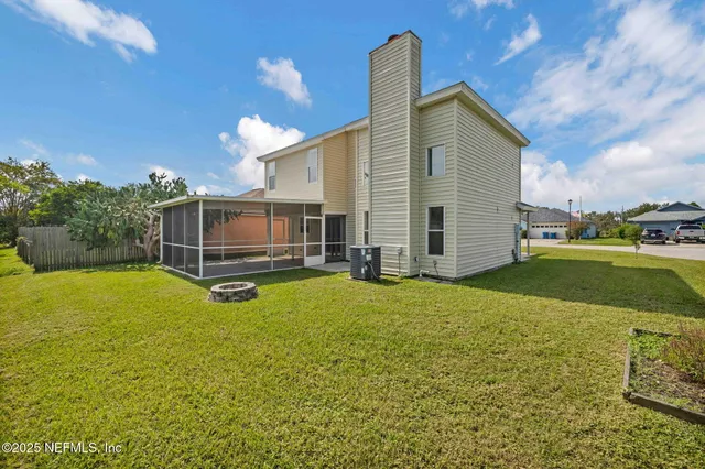 a view of a house with a backyard