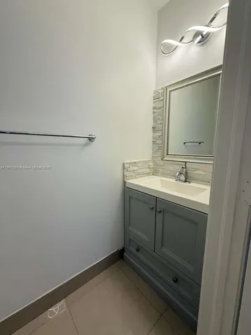a bathroom with a double vanity sink toilet and shower