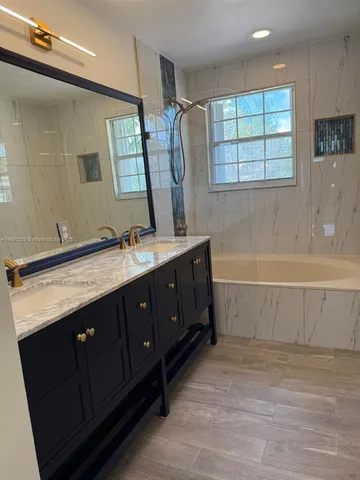 a bathroom with a double vanity sink toilet and shower