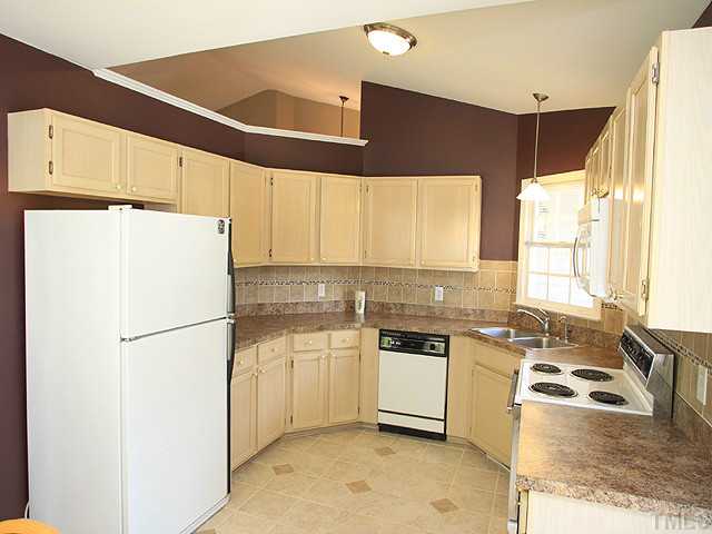 2904 Enson Place Raleigh, NC 27603 - Photo 9 of 25 Nicely updated kitchen with stone flooring and tile/glass backsplash.