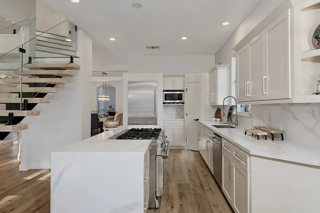 a view of a dining room with furniture and a chandelier