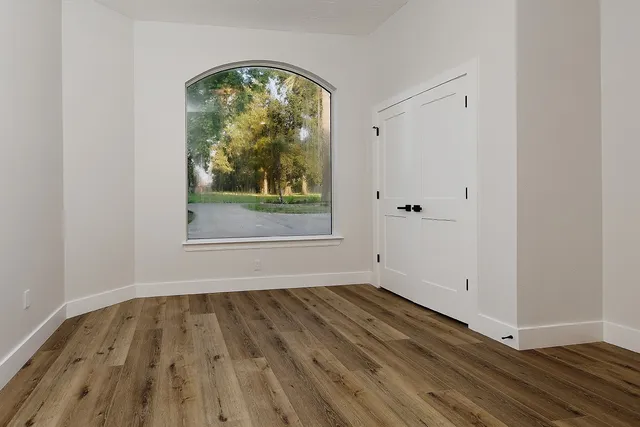 a view of a house with wooden deck next to a lake