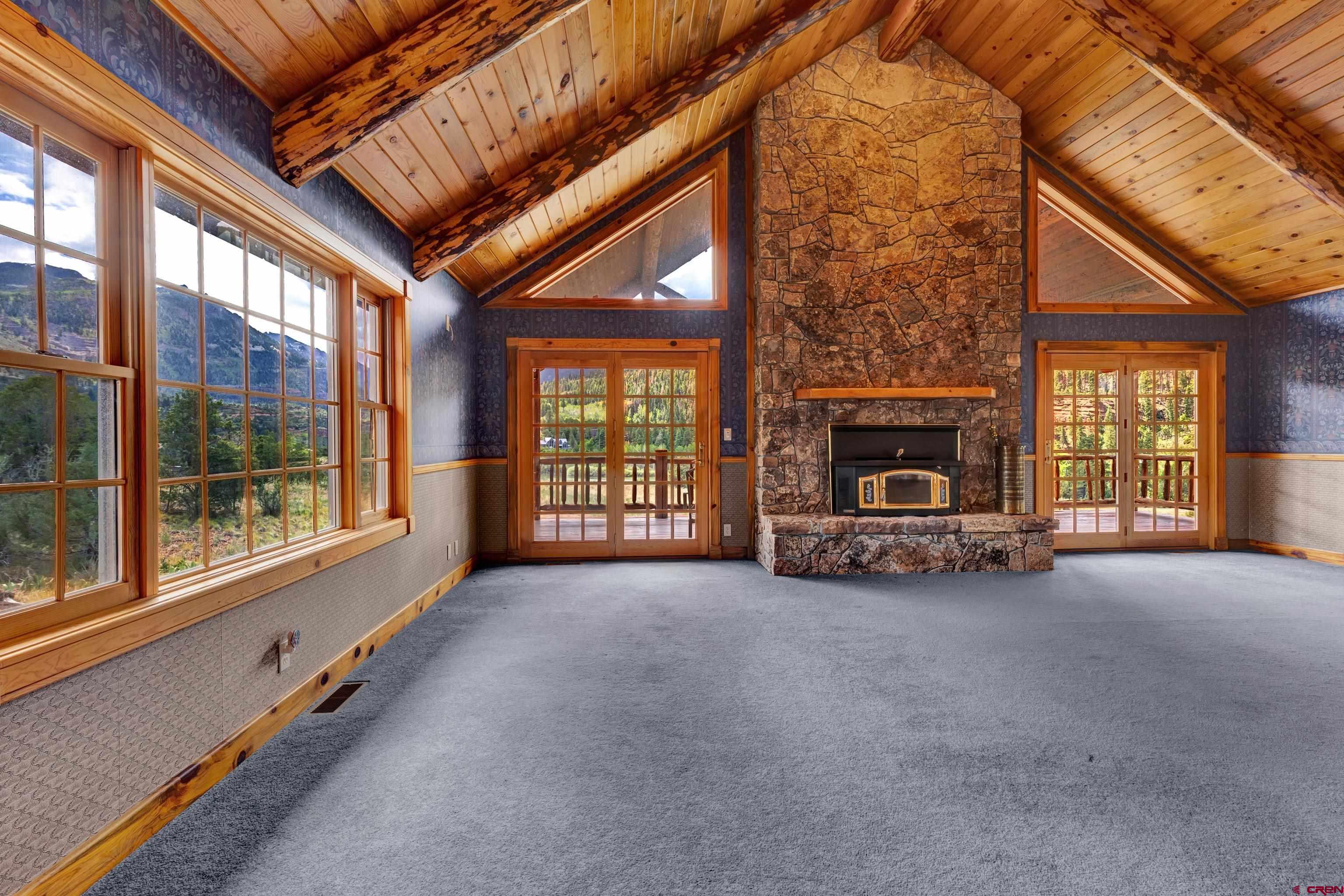 2692 County Road 17 Ridgway, CO 81432 - Photo 13 of 38 a view of an empty room with windows and a fireplace