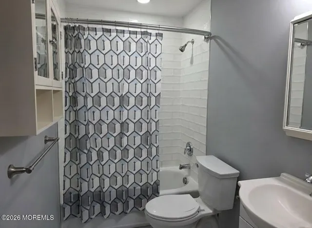 a white toilet sitting next to a bathroom sink