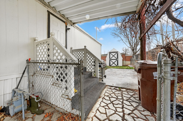 262 Hidden View Drive, Unit 94 Sandy, UT 84070 - Photo 18 of 18 View of patio featuring a shed