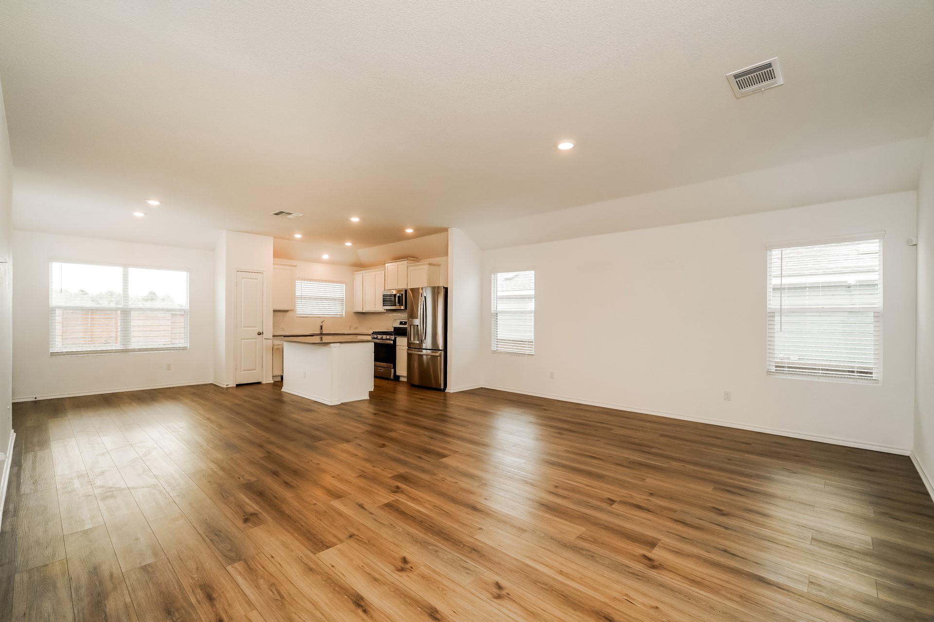 341 Madrid Kyle, TX 78640 - Photo 26 of 27 An open floorplan seamlessly connects the kitchen and living areas, offering effortless daily living.