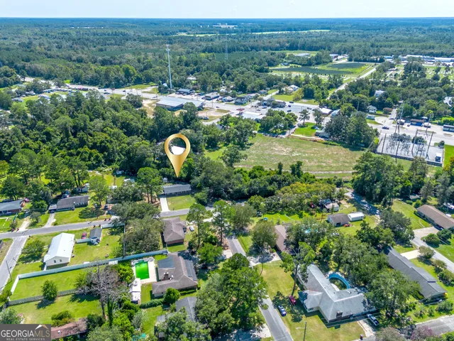 an aerial view of residential houses with outdoor space and river