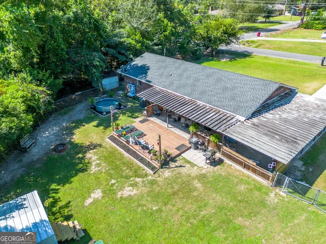 an aerial view of a house with a garden and swimming pool