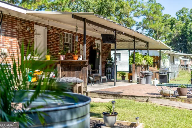 a view of a house with sitting area and garden