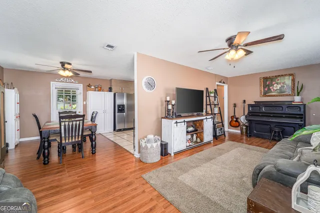 a view of a livingroom with furniture and a flat screen tv