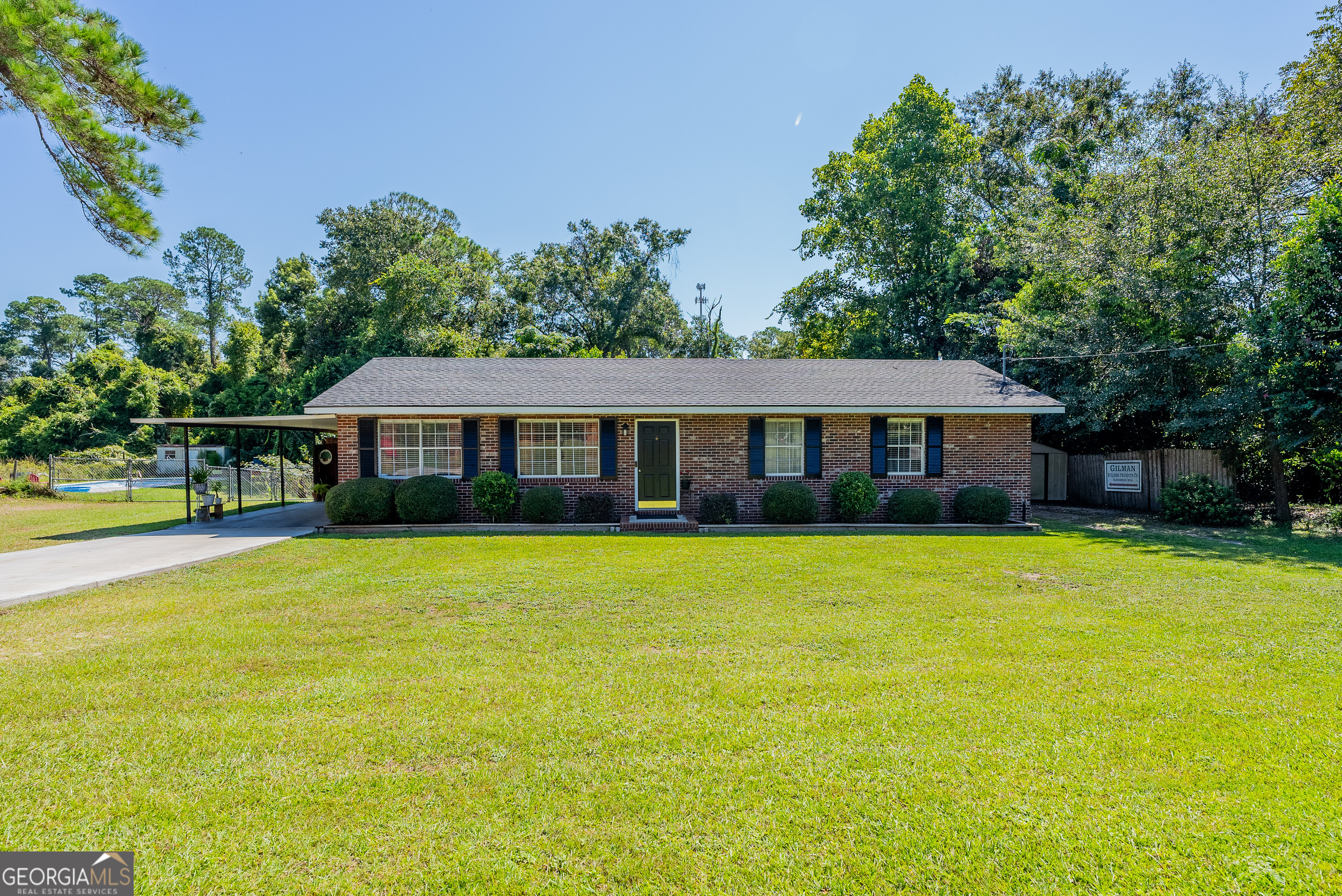 420 Jackson Street Blackshear, GA 31516 - Photo 2 of 31 a front view of a house with yard and green space