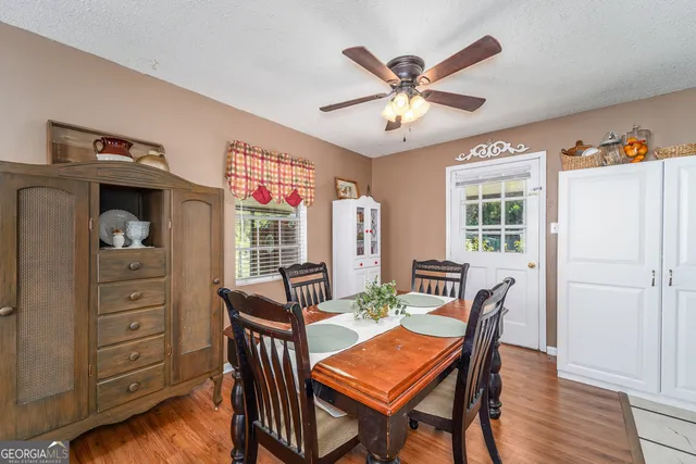 a view of a dining room with furniture window and wooden floor