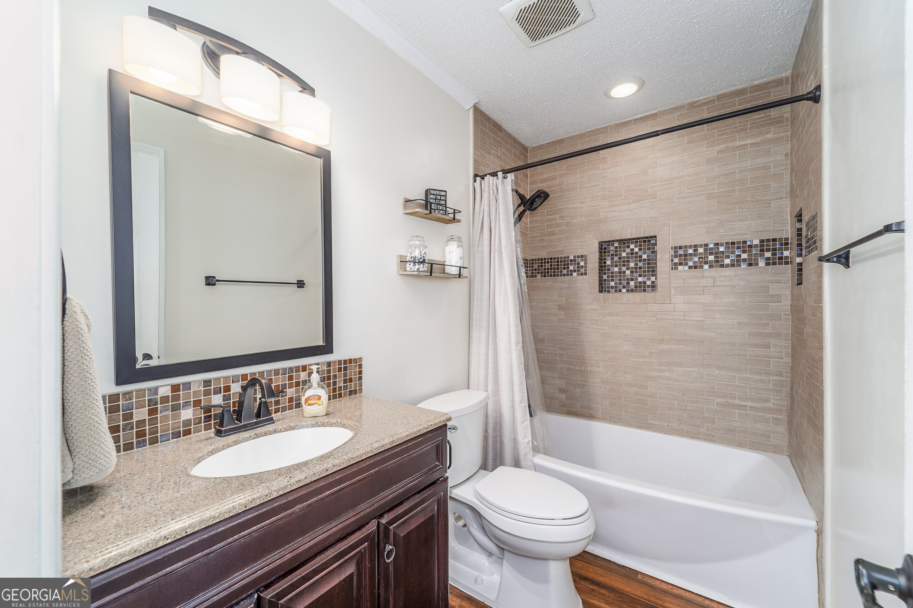 420 Jackson Street Blackshear, GA 31516 - Photo 27 of 31 a bathroom with a granite countertop sink toilet and shower