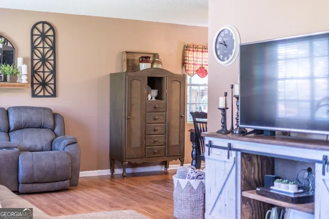 a living room with furniture and wooden floor