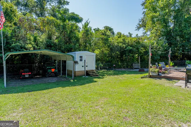 a view of a house with backyard and a tree
