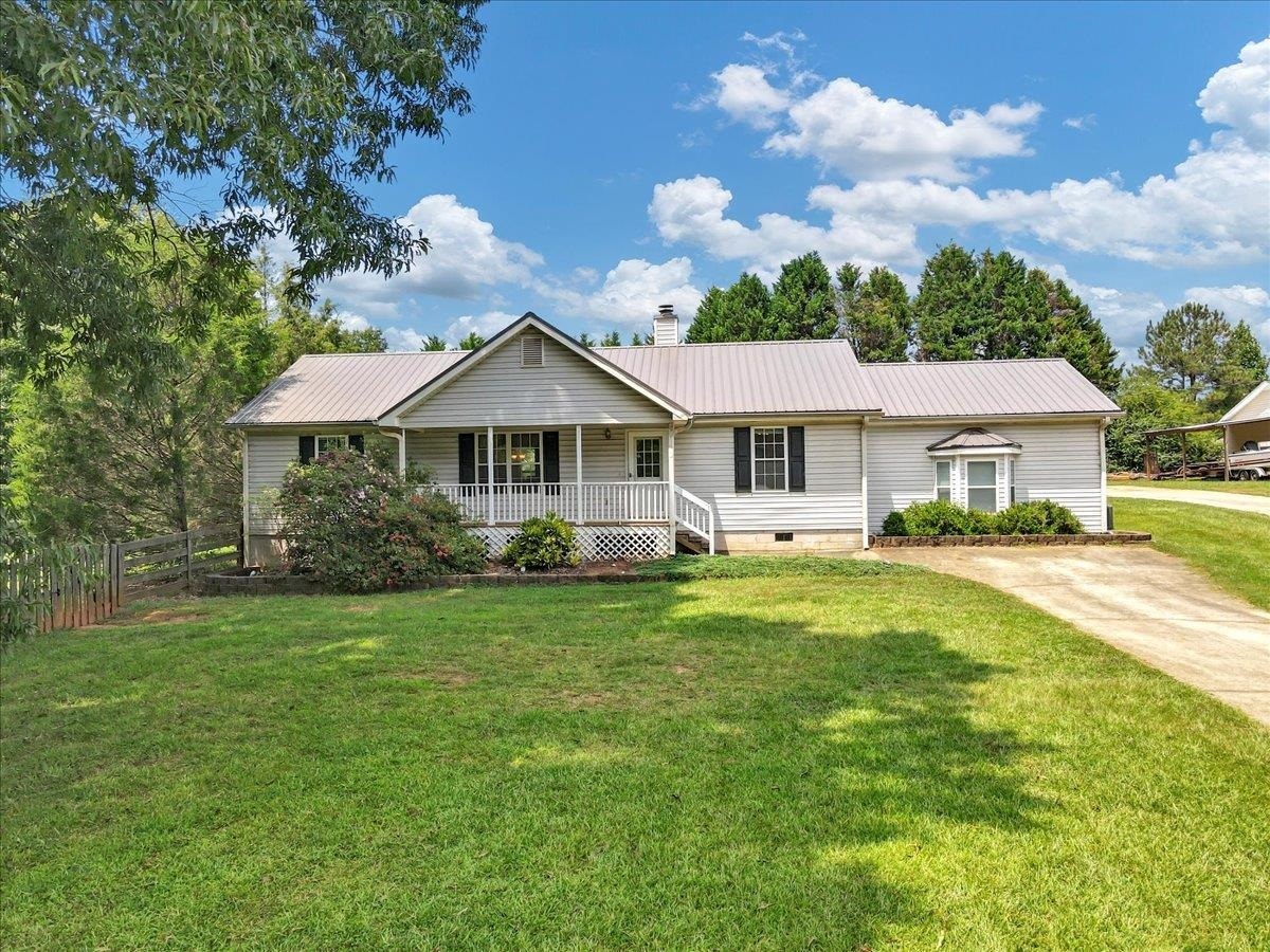 1212 South Ola Road Locust Grove, GA 30248 - Photo 1 of 1 a front view of a house with a garden