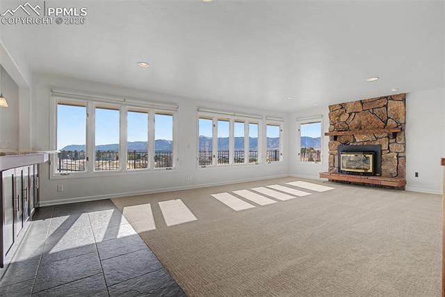 733 Bowstring Road Monument, CO 80132 - Photo 8 of 45 A wall of windows floods the room with light