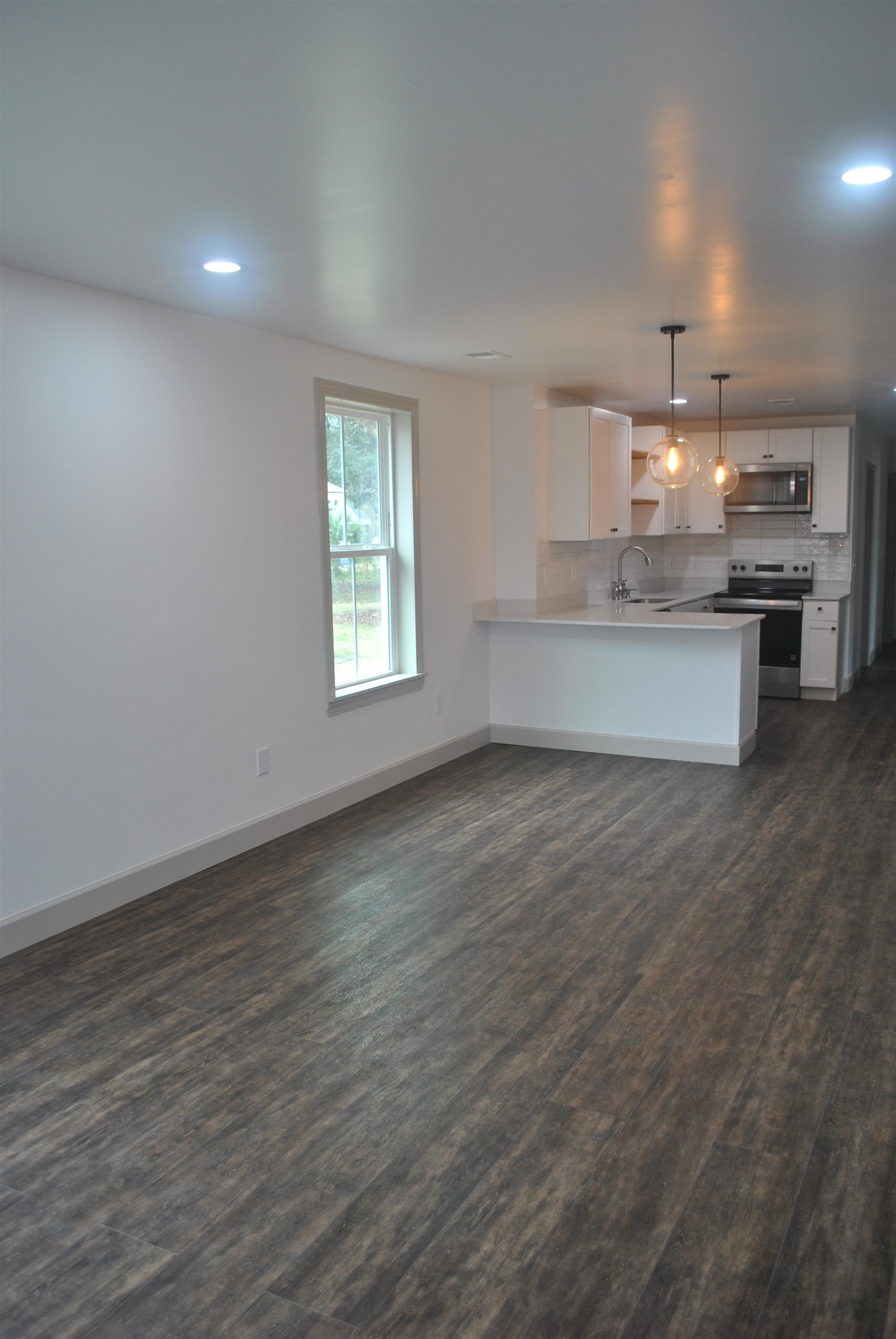 815 North Congdon Street Georgetown, SC 29440 - Photo 6 of 28 Unfurnished living room with dark wood-type flooring and recessed lighting
