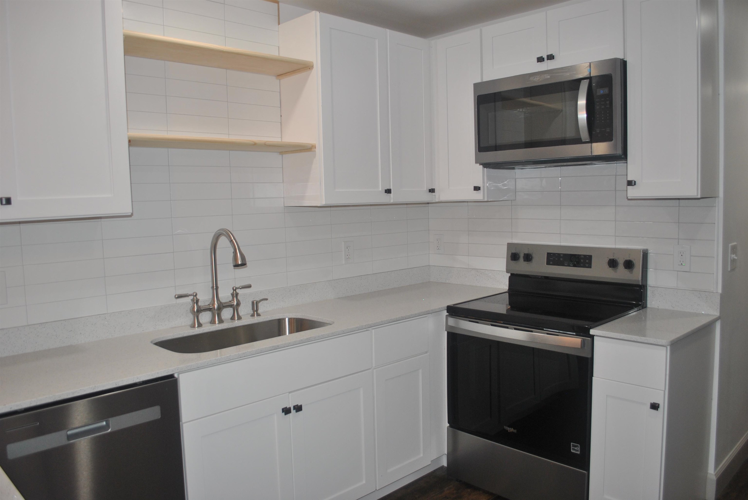 815 North Congdon Street Georgetown, SC 29440 - Photo 10 of 28 Kitchen with appliances with stainless steel finishes, open shelves, and white cabinets