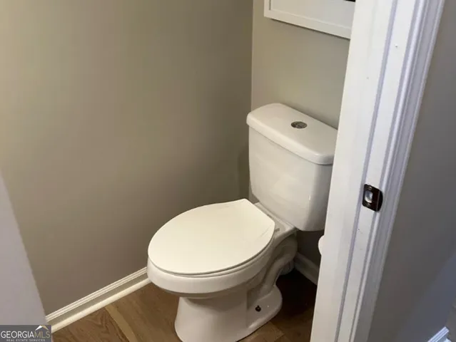 a white toilet sitting next to a small sink