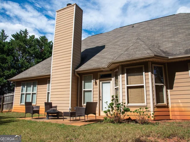 a front view of a house with sitting area