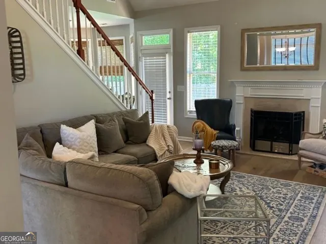 a living room with furniture and a fireplace