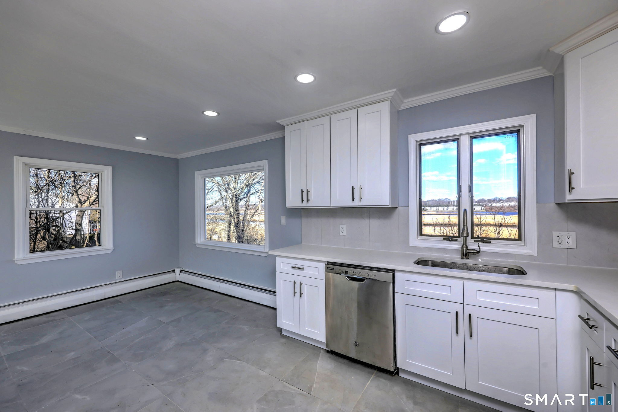 206 Bridgeview Place Stratford, CT 06614 - Photo 12 of 34 a kitchen with white cabinets window and sink