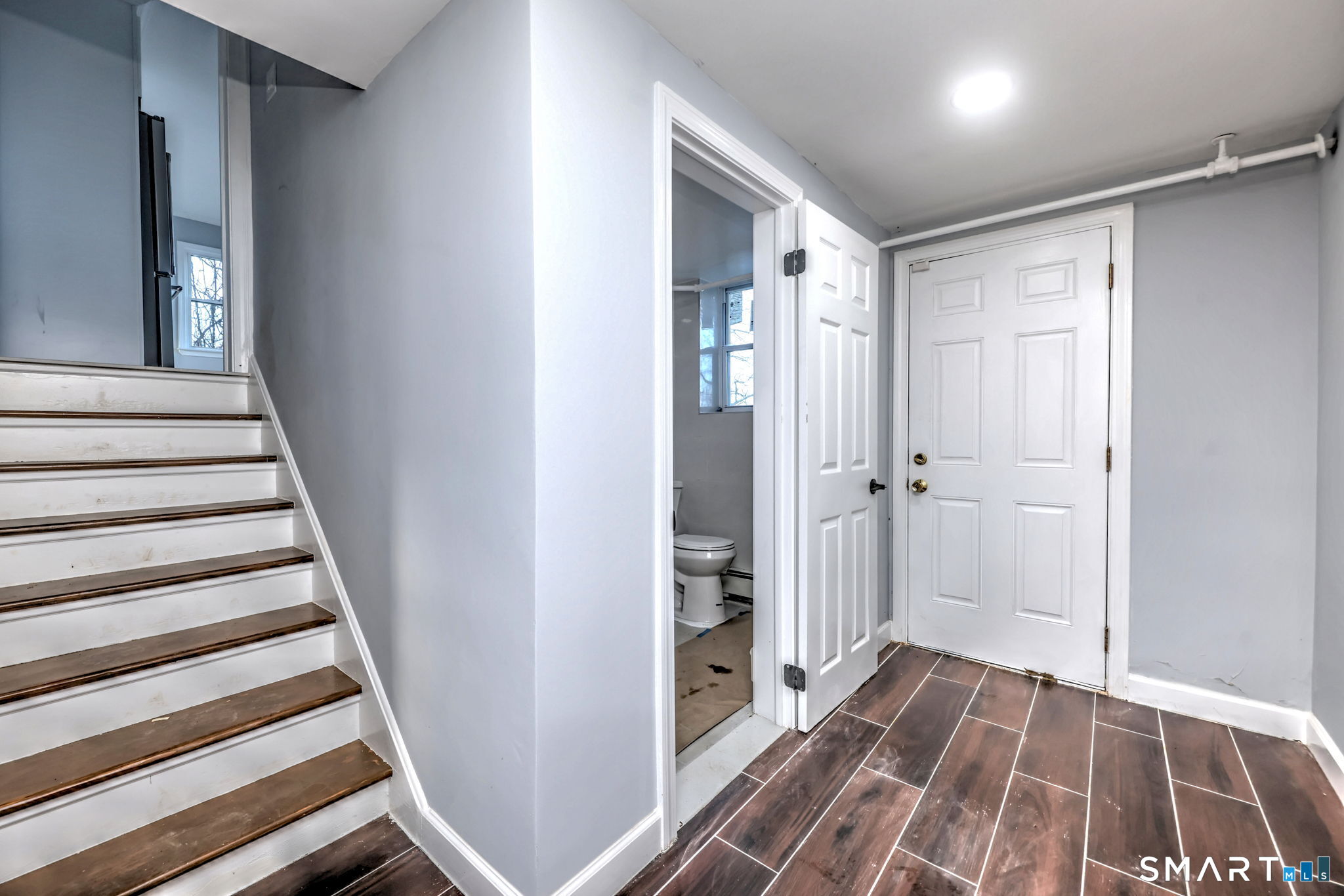 206 Bridgeview Place Stratford, CT 06614 - Photo 22 of 34 a view of a hallway with wooden floor and staircase