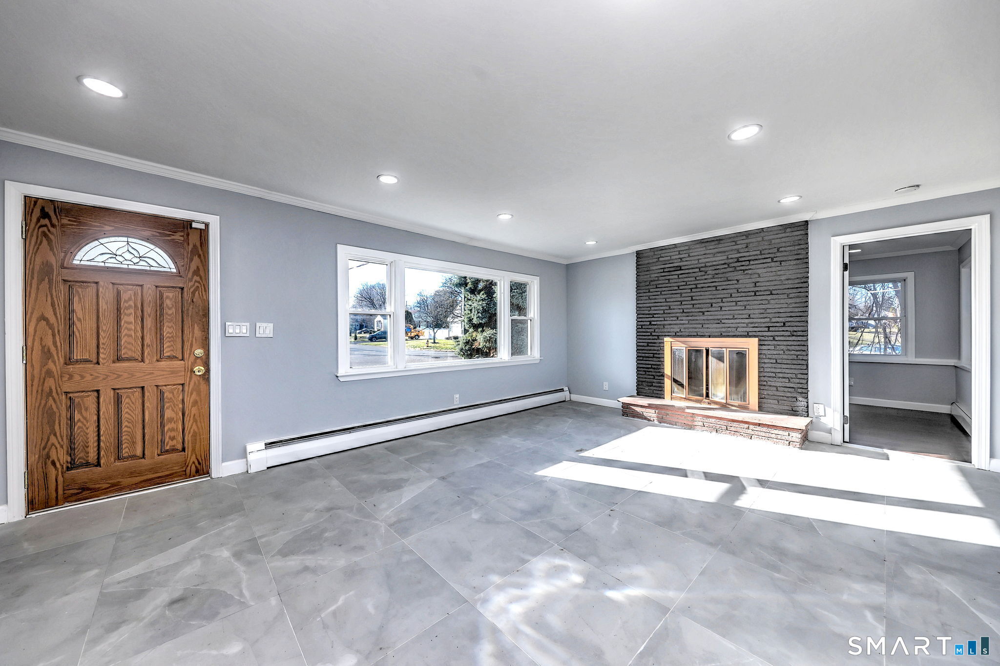 206 Bridgeview Place Stratford, CT 06614 - Photo 5 of 34 an empty room with windows and fireplace