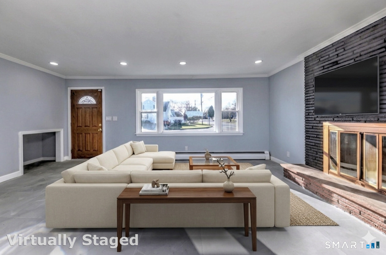 206 Bridgeview Place Stratford, CT 06614 - Photo 6 of 34 a living room with furniture a flat screen tv and a fireplace