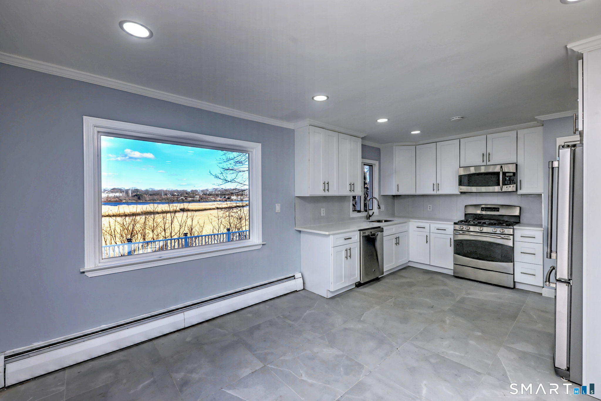 206 Bridgeview Place Stratford, CT 06614 - Photo 10 of 34 a kitchen with a refrigerator and a stove top oven