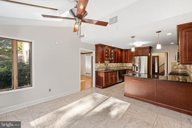 a large kitchen with a large counter top appliances and cabinets