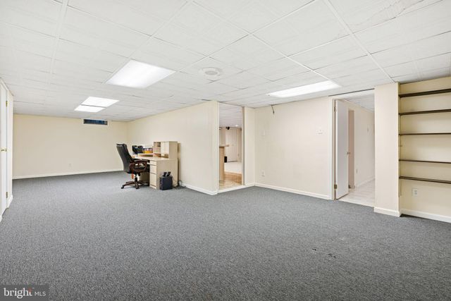 a view of a livingroom with chairs and closet