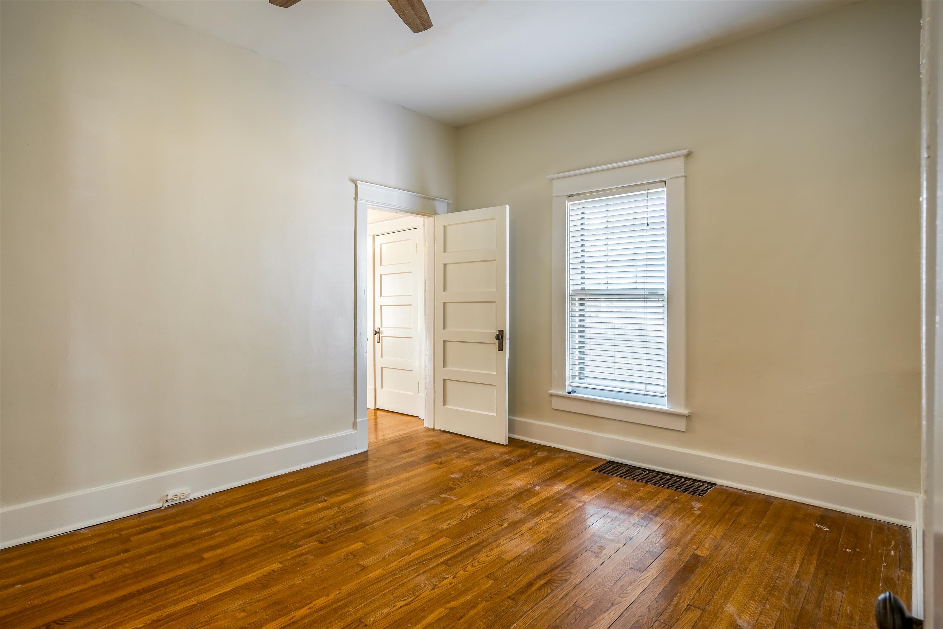 1997 Harbert Avenue Memphis, TN 38104 - Photo 14 of 23 an empty room with wooden floor and windows