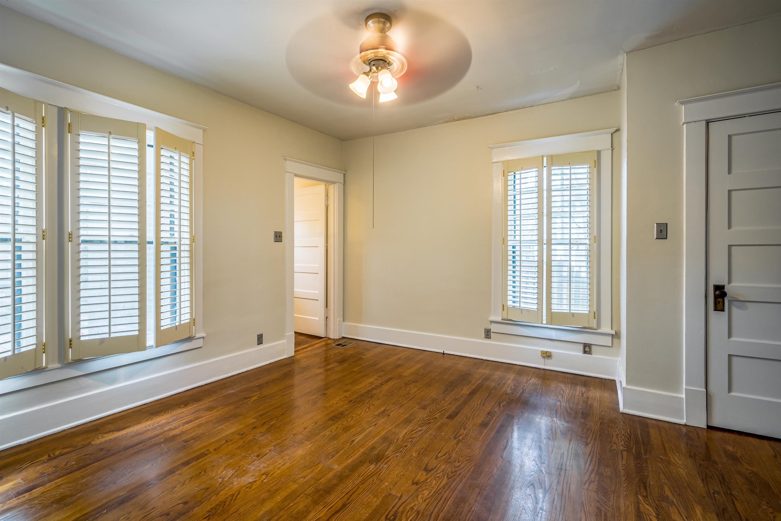 1997 Harbert Avenue Memphis, TN 38104 - Photo 15 of 23 an empty room with wooden floor and windows