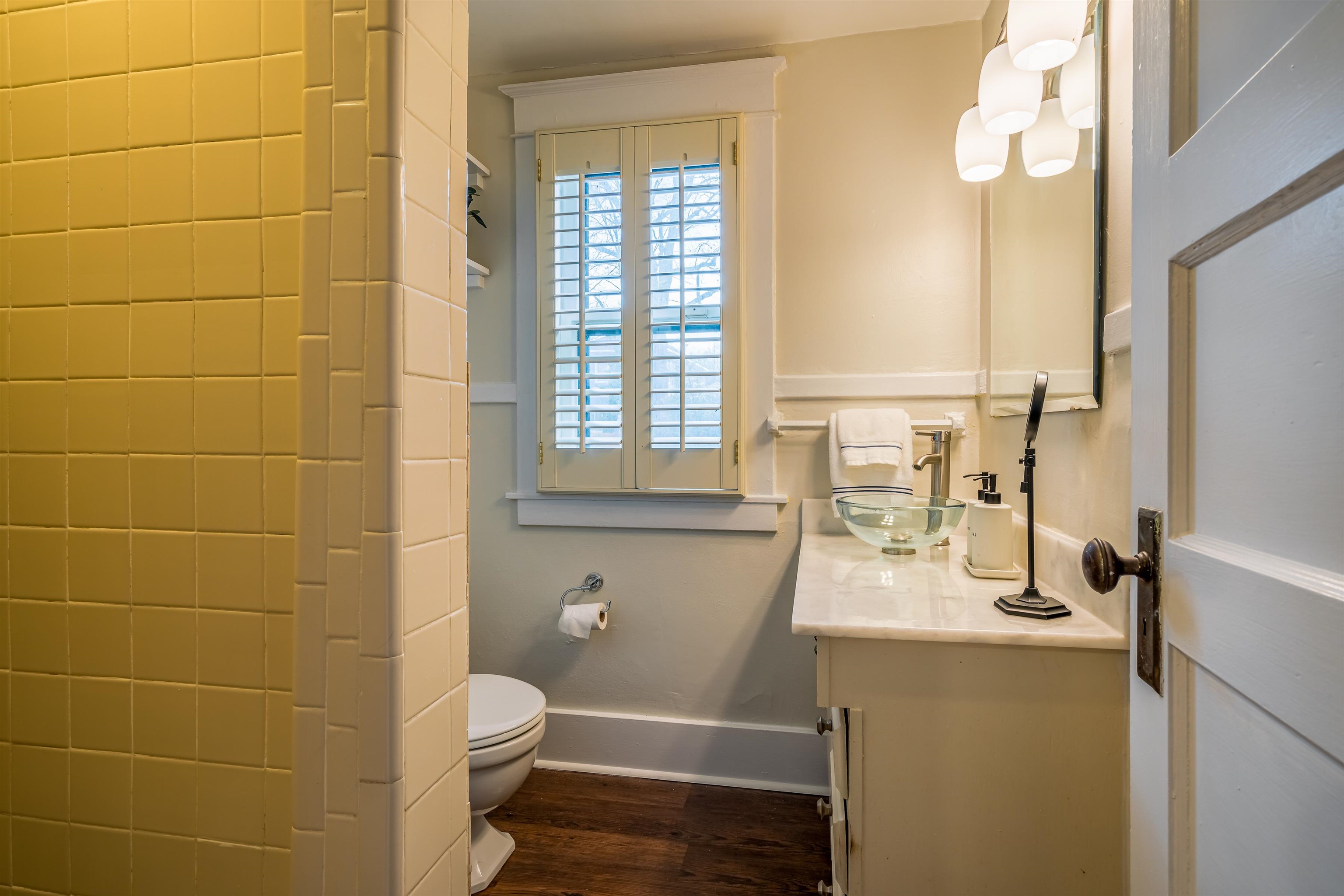 1997 Harbert Avenue Memphis, TN 38104 - Photo 16 of 23 a bathroom with a granite countertop toilet sink and mirror