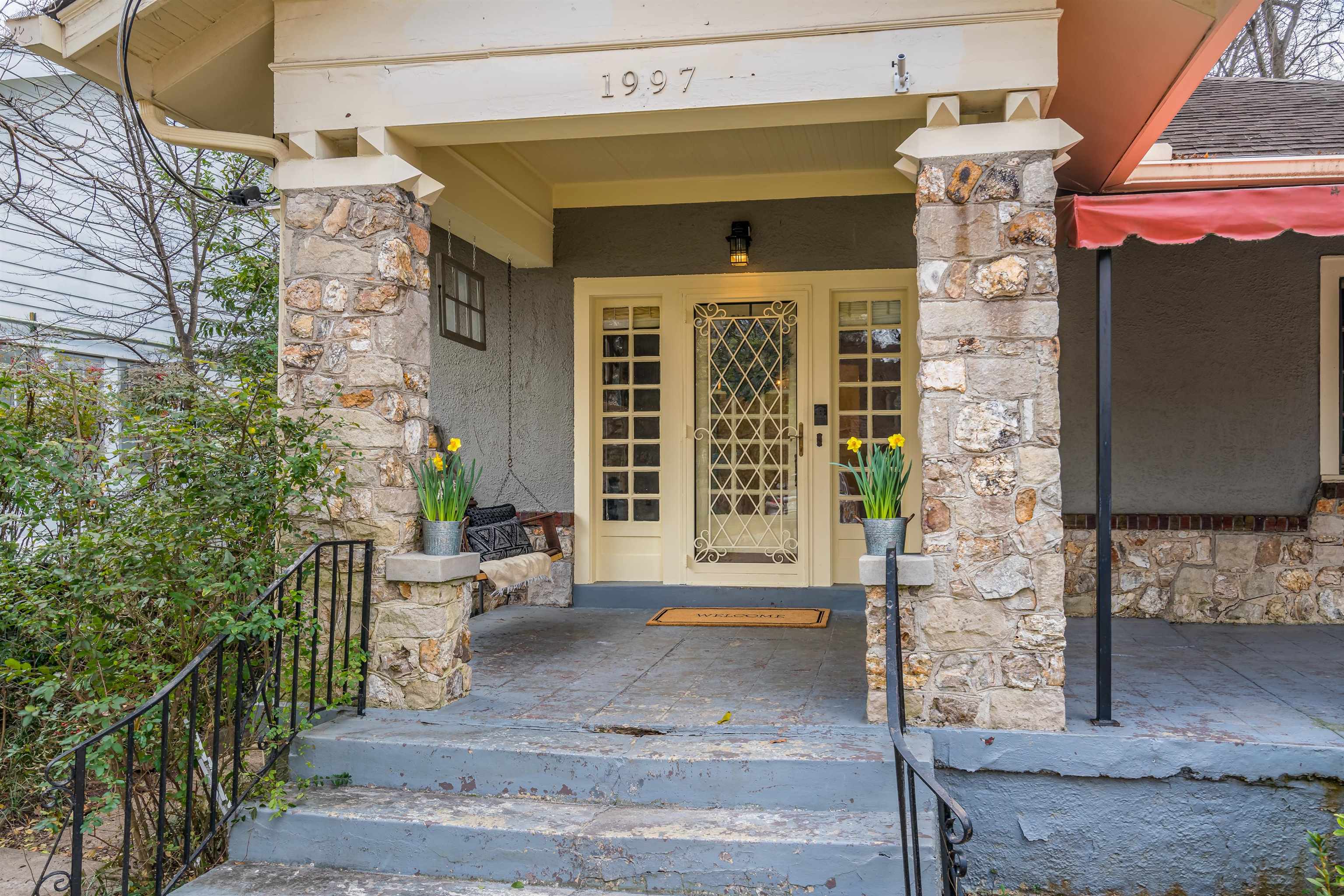 1997 Harbert Avenue Memphis, TN 38104 - Photo 2 of 23 a front view of a house with outdoor seating