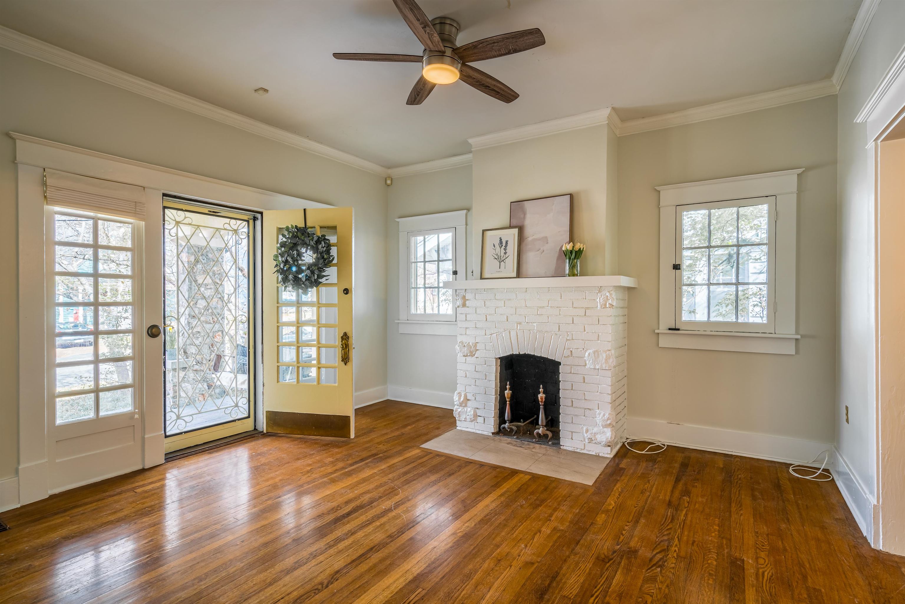 1997 Harbert Avenue Memphis, TN 38104 - Photo 4 of 23 a view of empty room with wooden floor and fireplace