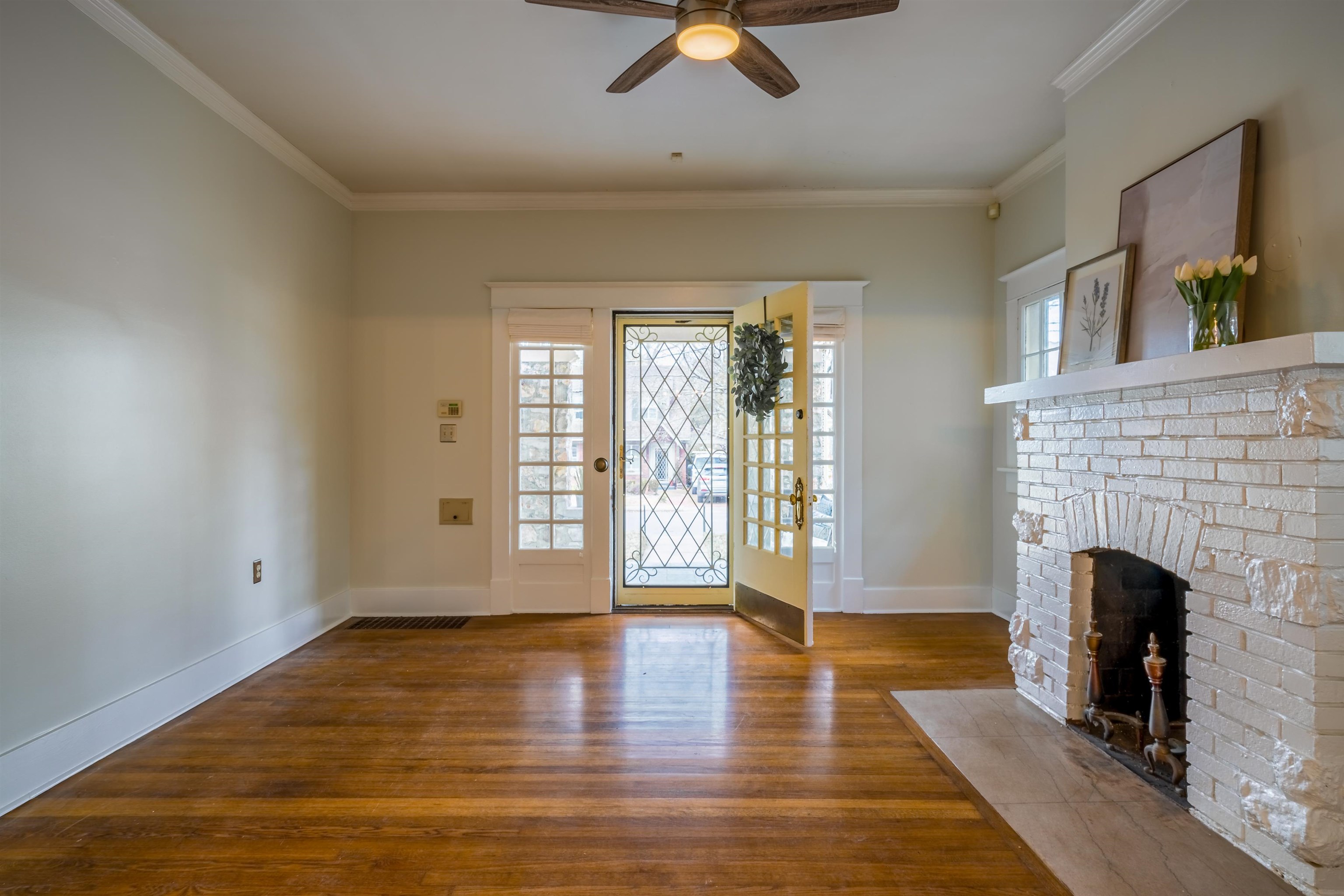 1997 Harbert Avenue Memphis, TN 38104 - Photo 5 of 23 a view of an empty room with exposed radiator and fireplace