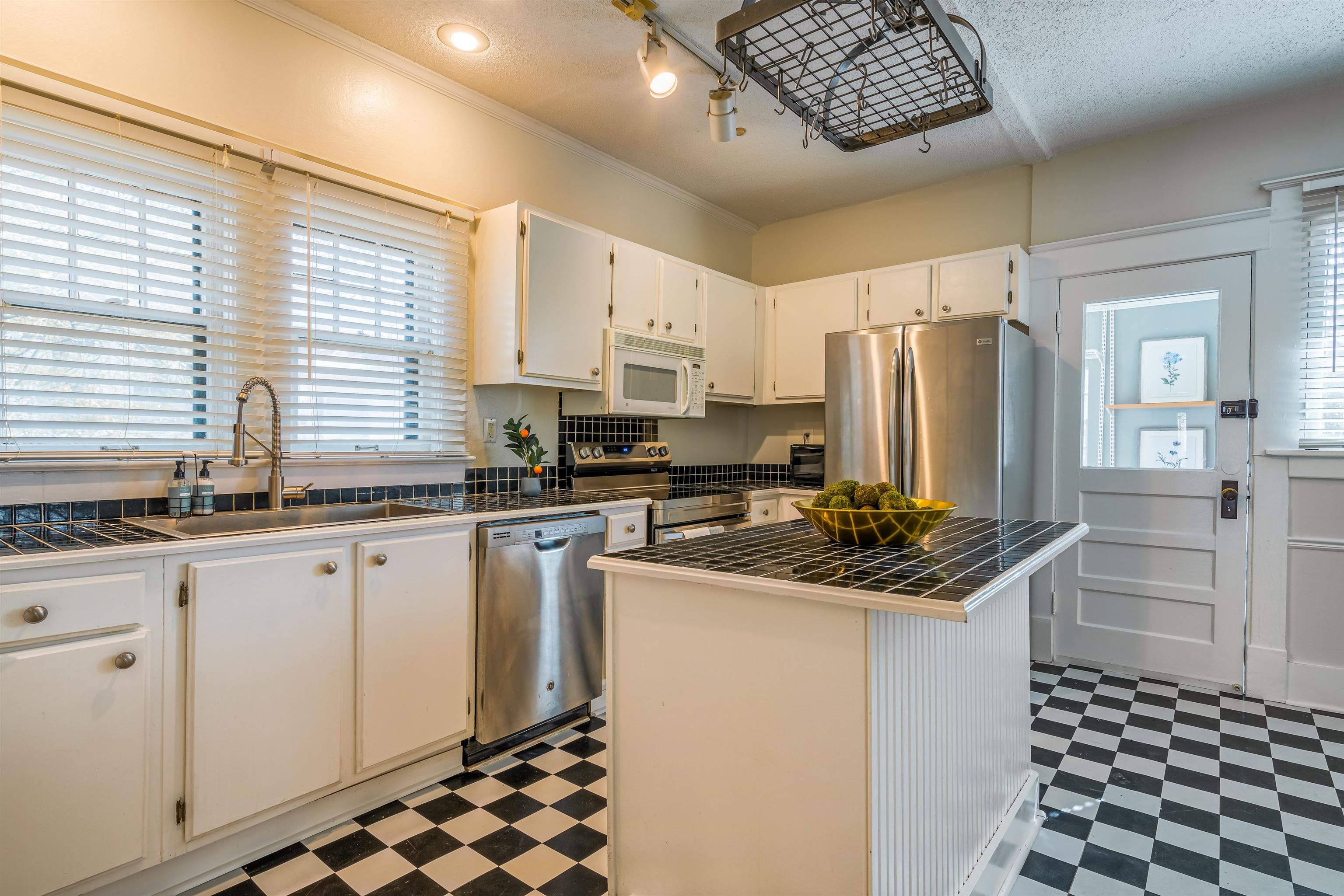 1997 Harbert Avenue Memphis, TN 38104 - Photo 9 of 23 a kitchen with stainless steel appliances a refrigerator sink and cabinets