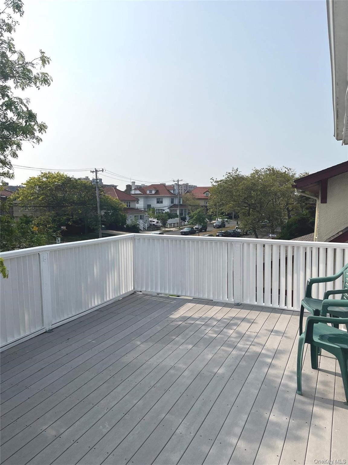 307 Magnolia Boulevard, Unit UPPR Long Beach, NY 11561 - Photo 15 of 17 a view of a balcony with wooden floor and fence