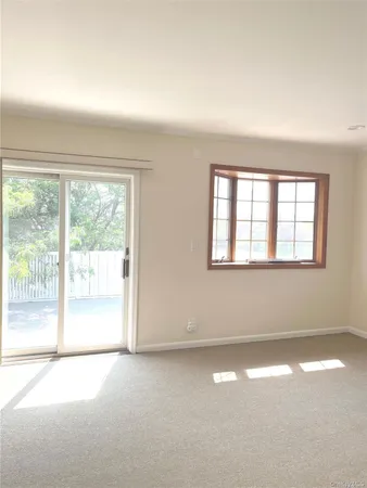 a view of empty room with floor to ceiling window