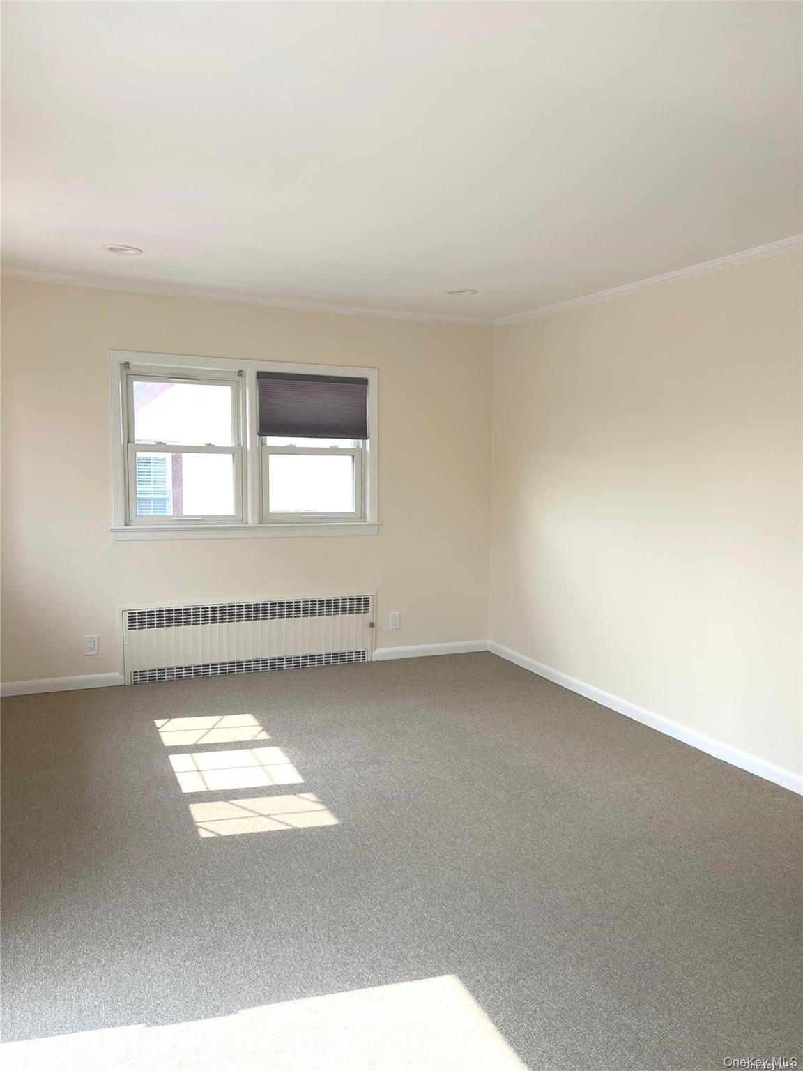 307 Magnolia Boulevard, Unit UPPR Long Beach, NY 11561 - Photo 6 of 17 an empty room with windows