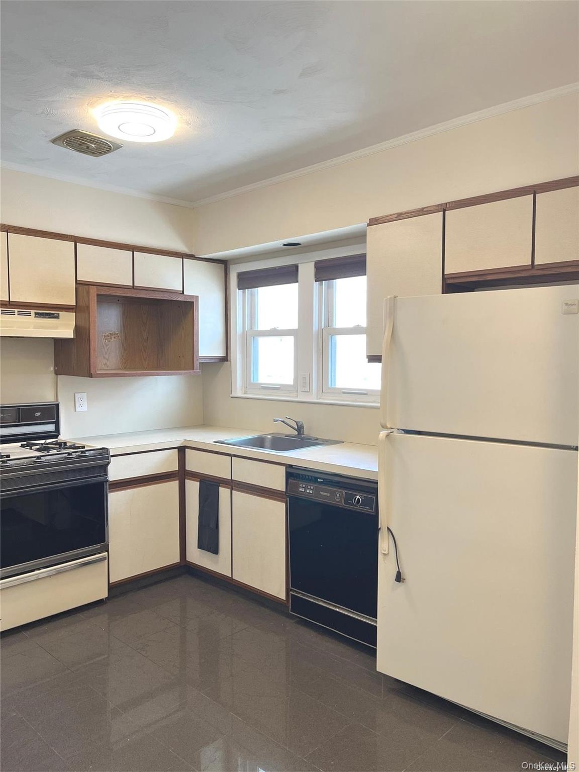 307 Magnolia Boulevard, Unit UPPR Long Beach, NY 11561 - Photo 7 of 17 a kitchen with stainless steel appliances granite countertop refrigerator sink and stove