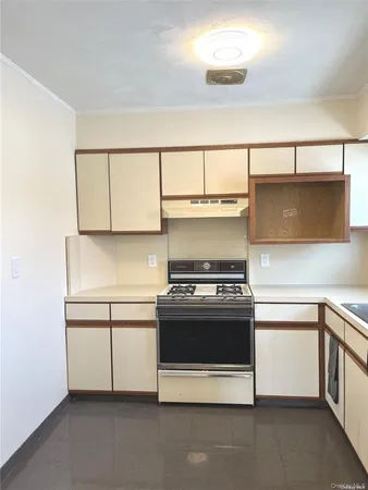 a kitchen with a stove and white cabinets