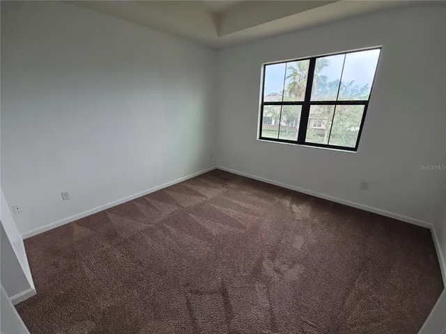 a white toilet sitting next to a white wall