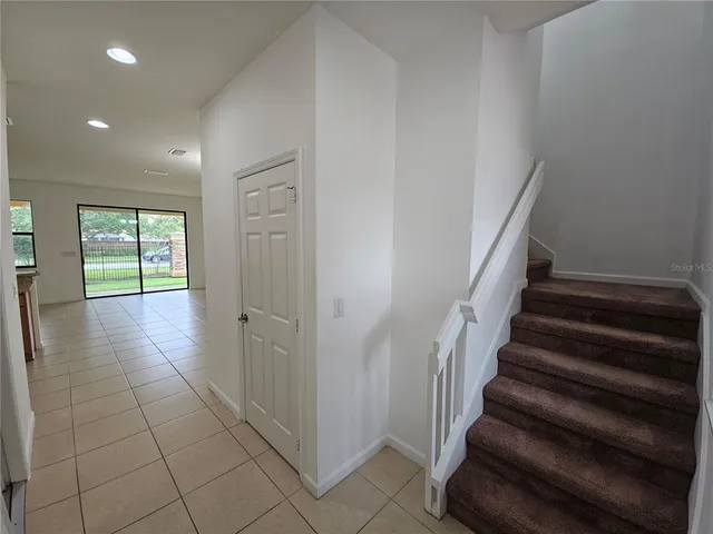 an empty room with windows and entrance