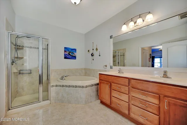 a spacious bathroom with a double vanity sink mirror and toilet