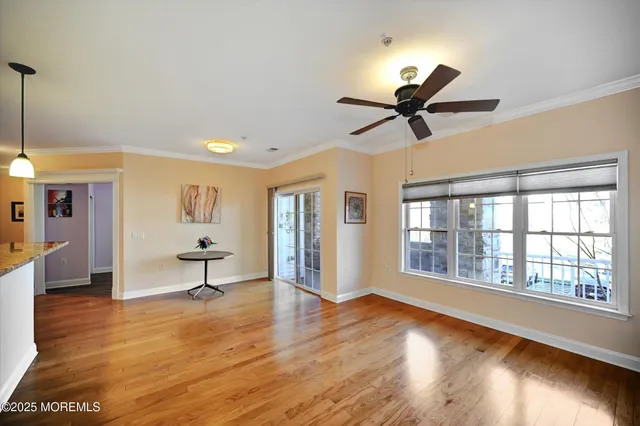 a view of a living room a window and a ceiling fan